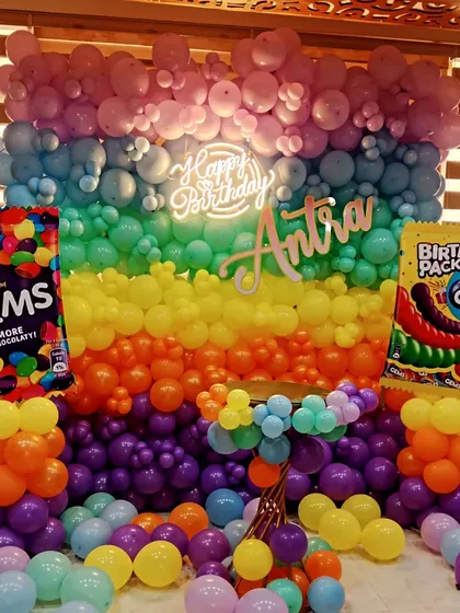 Another angle of the vibrant Gems-themed birthday party, showing the full balloon wall.