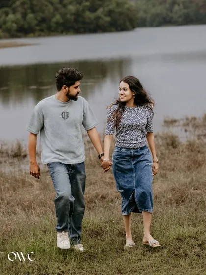 A casual stroll hand-in-hand by the lake, this pre-wedding photo captures a simple, happy moment.