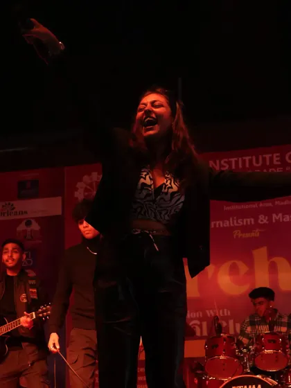 On stage with a live band behind me at the Tecnia Institute Media Fest. This is me in my element, feeding off the crowd's energy and giving it right back.