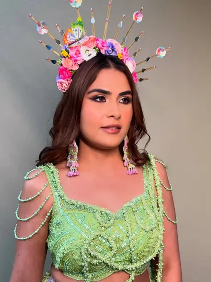 Another angle of the carnival makeup. The defined eyes and glowing skin provide the perfect base for the show-stopping headgear.