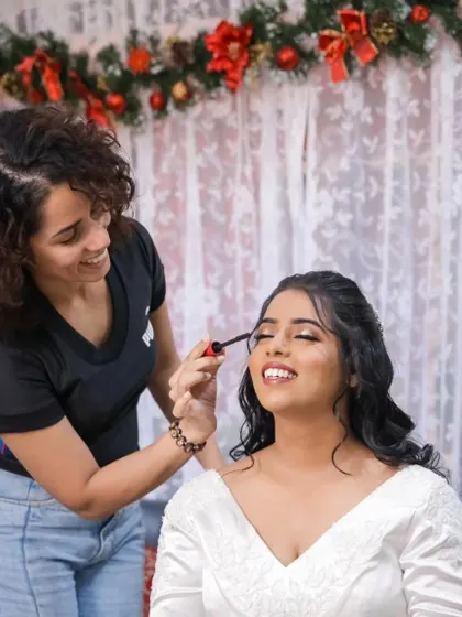 Sharing a laugh while getting ready. These moments of connection are what make the experience so memorable. Here I am applying mascara for that final touch of drama.