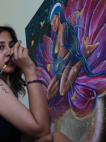 A moment of focus while working on the intricate details of the lotus and the figure, channeling a sense of peace into the brushstrokes.