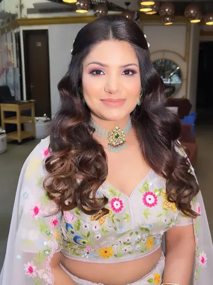 A closer view of the makeup, highlighting the soft pink tones on her eyes and cheeks that complement the floral embroidery on her lehenga.