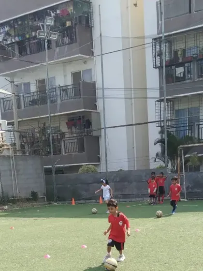 A young player dribbling the ball at one of our grassroots centers, where we believe in making the game enjoyable from the very first kick.
