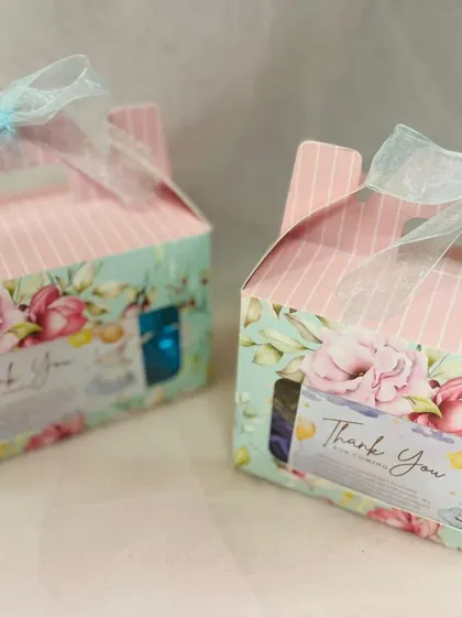 Two of the completed return favor boxes, showing the window design that gives a little peek at the treats inside.