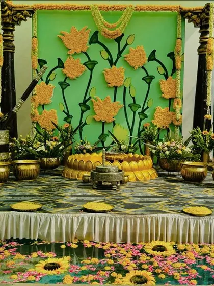 The vibrant Haldi stage by the water, with floating flowers in the pool adding an extra layer of thoughtful detail to the celebration.