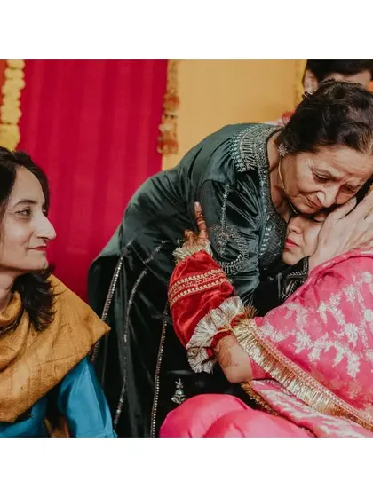An emotional moment during the Chooda ceremony as the bride shares a hug with her mother. These rituals are filled with deep emotional significance.