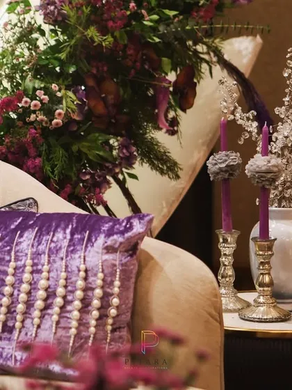 Texture and detail are everything. A close-up of the plush, pearl-studded velvet cushion, which adds another layer of luxury and tactile richness to the lounge seating.