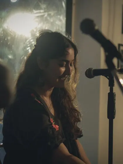 A vocalist sharing a quiet, heartfelt moment with the audience. The intimacy of our space makes these connections possible.