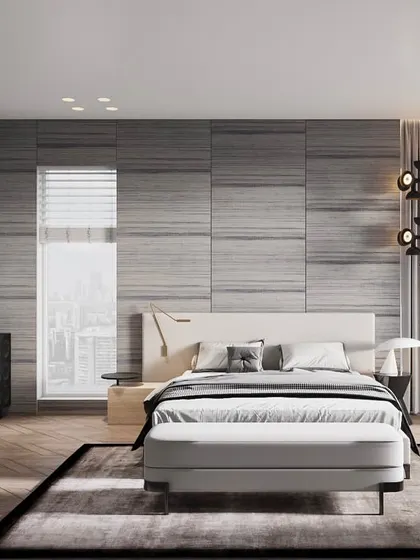 I love creating cozy bedrooms layered with textures and neutral tones. This design uses horizontally-paneled grey walls, a sculptural black dresser, and warm wooden floors to create a sophisticated and calming space with a beautiful city view.