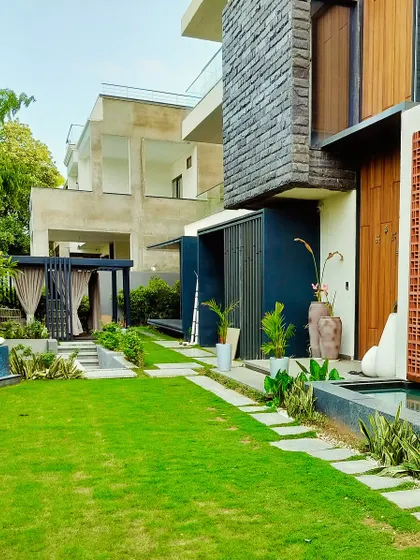 This angle showcases the relationship between the house, the lawn, and the water feature, all connected by a stepping stone path.