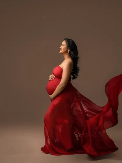 Looking up with hope and joy. The movement in this red fabric adds a sense of freedom and power to the portrait.