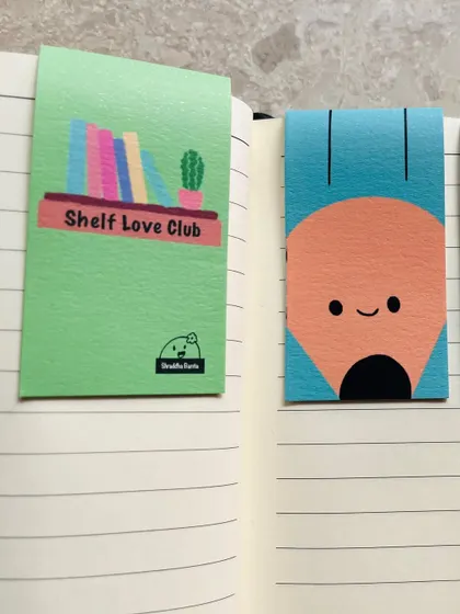 A close-up of the "Shelf Love Club" and pencil magnetic bookmarks.