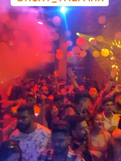 A still from the video, showing the explosive energy of the crowd under a shower of balloons.