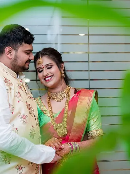 A candid, happy moment between a couple, framed by greenery. We love capturing the natural joy you share.