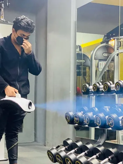Using a fogging machine to disinfect the dumbbell area. This allows us to sanitize large areas and equipment efficiently and effectively.