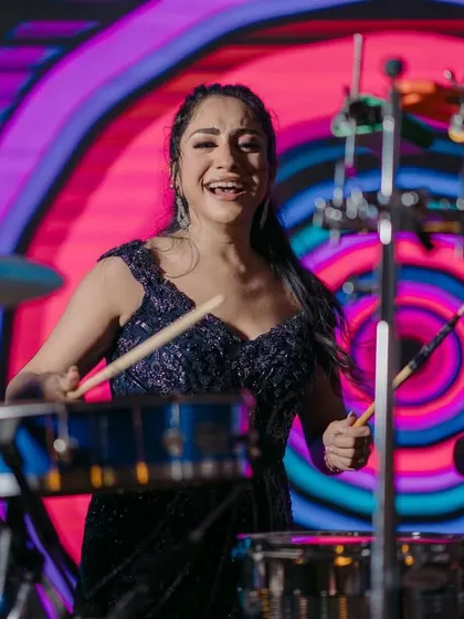 The bride takes over the drums. A super fun and unique candid moment from a sangeet night, showing her joyful and energetic personality.