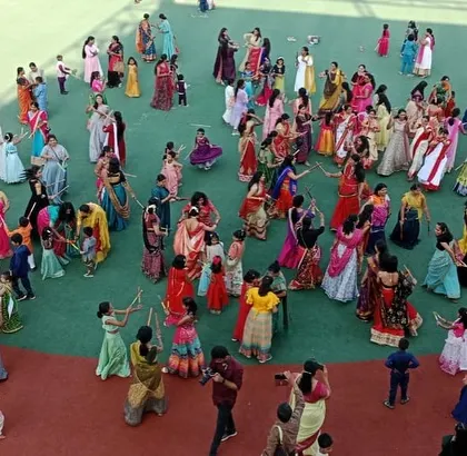 The entire ground is filled with dancing families, celebrating Navratri with joy and togetherness.