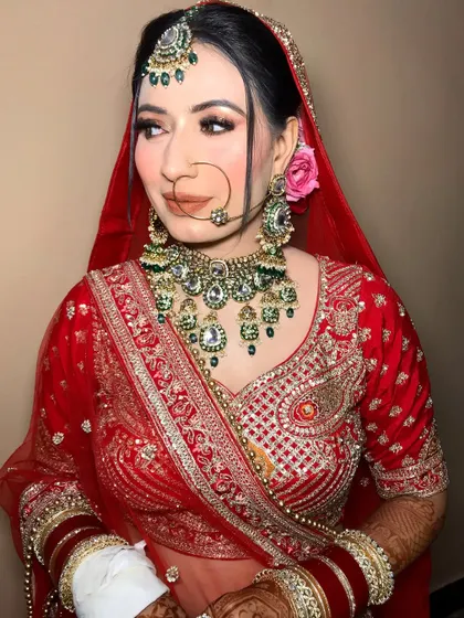 A side profile showing the beautiful hairstyle and the way the dupatta frames her face.