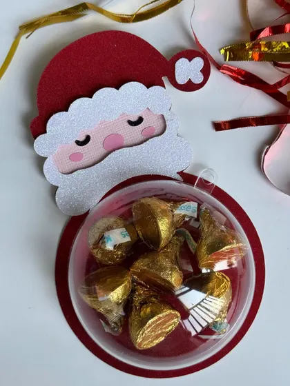 A cute sleeping Santa Claus handmade bauble, perfect for holding holiday treats.