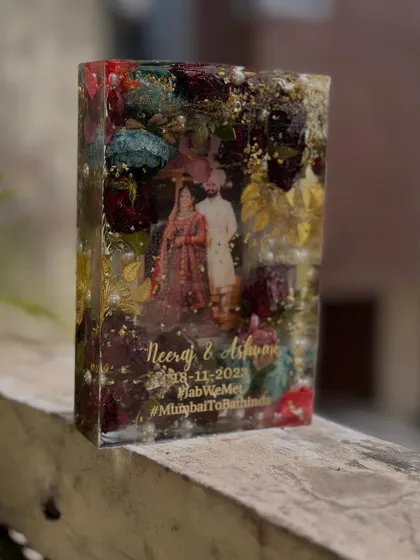This deep rectangular block is a burst of color, preserving a multi-hued varmala around the couple's wedding photo. The depth allows for a beautiful 3D arrangement of the flowers.