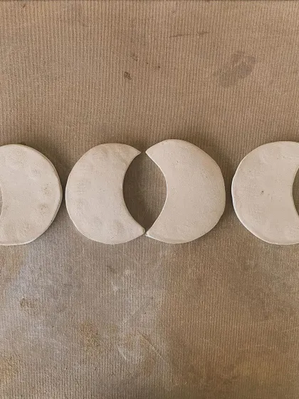 Four moon-phase trinket dishes, hand-built from white clay. These are perfect for holding jewelry or simply as a beautiful, minimalist decoration.