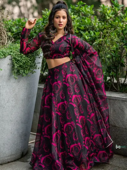 A strong and poised portrait. The subject's pose and expression give this traditional lehenga a modern, high-fashion attitude.