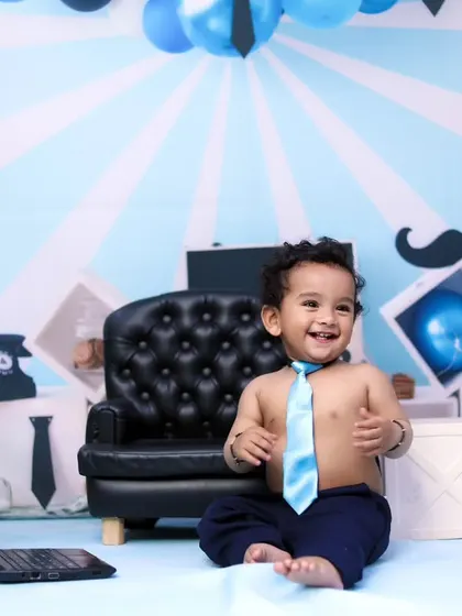 A happy 'Boss Baby' enjoying his office setup. The tie and big smile make this shot priceless.