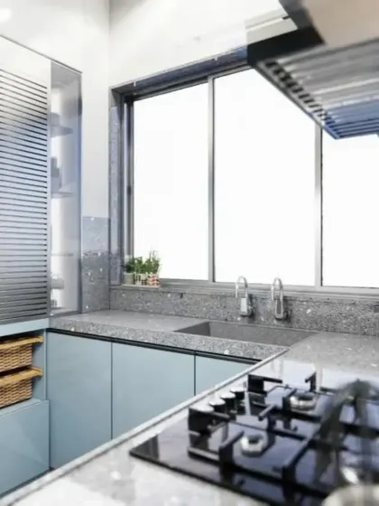 This angle shows the smart storage solutions, including a vertical pantry with wicker baskets, perfect for organizing your kitchen.