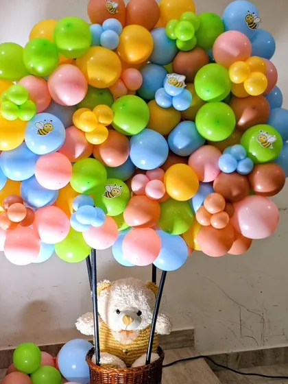 A close-up of a hot air balloon prop from the honeybee-themed party, filled with colorful balloons and cute bee stickers.