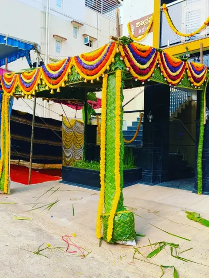 A chapra being set up for a housewarming ceremony. Even in progress, you can see the structure taking shape to create a welcoming arch.