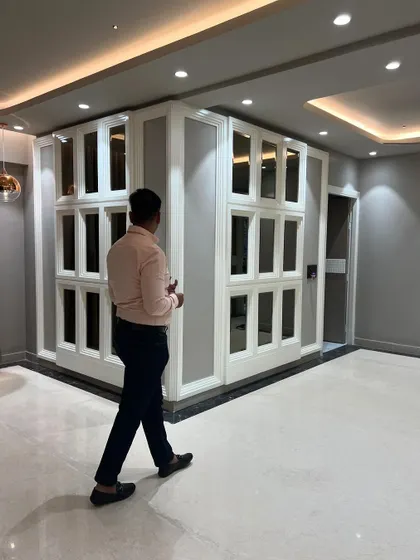 A nearly complete living space featuring a large, mirrored panel wall. This design element makes the room feel larger and brighter while adding a touch of classic elegance.