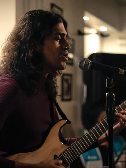 A guitarist and vocalist from the band Fifiroro, delivering an electrifying performance. We are a launchpad for exciting new bands on the Bangalore music scene.