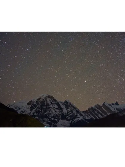 The Milky Way and a universe of stars shine brightly over the Annapurna mountain range, a truly unforgettable sight from our high-altitude camps.