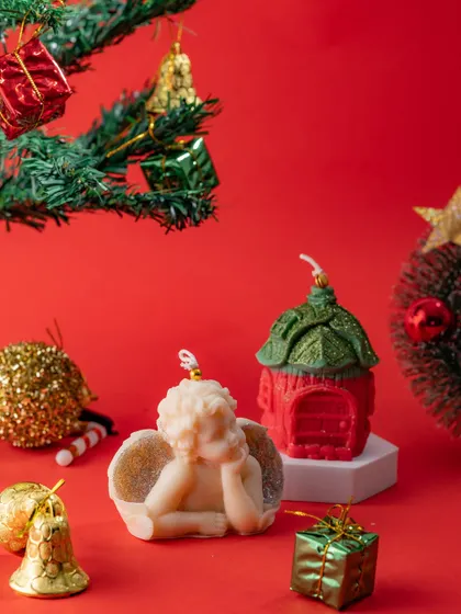My Christmas-themed sculptural candles, featuring a serene angel and a little red house. These are perfect for creating a festive and magical atmosphere during the holidays.