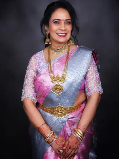 A classic pose that displays the intricate details of the jewelry and the elegant fall of the saree, creating a timeless and graceful silhouette.
