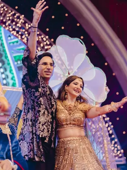 A grand entry onto the Sangeet stage, ready to kick off a night of performances and celebration.