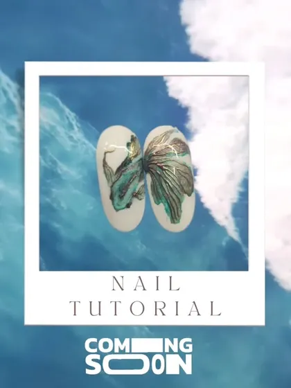 A teaser for our upcoming August nail trend, featuring a beautiful hand-painted fish design against an ocean-blue background. Stay tuned for the full tutorial.