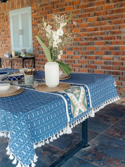 Our blue patterned tablecloth with tassel details creates a beautiful foundation for this summer dining setup. The design is inspired by traditional motifs, perfect for both casual and formal gatherings.