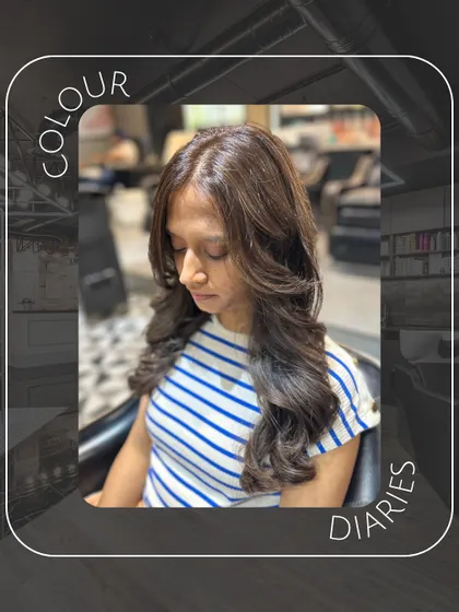 This image captures the soft, elegant feel of a fresh hair color and style. The lighting highlights the glossy finish of her new brown hair.