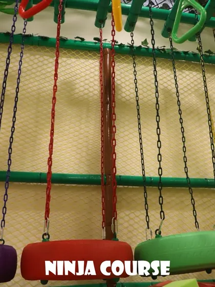The ninja course features a series of hanging obstacles like these tire swings and rings. It's designed to be a fun physical challenge for active kids.