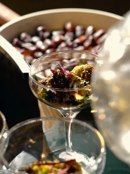A close-up of our Khajur Ki Chaat being served. The combination of sweet dates, crunchy sev, and tangy chutneys creates a burst of flavor in every bite.