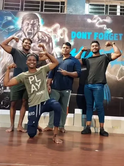Posing with the crew in front of our gym's mural. We live and breathe the hustle.