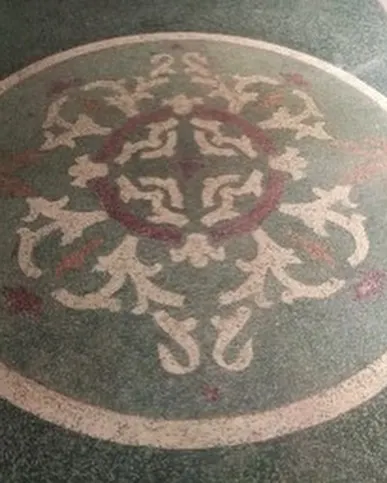 A beautiful circular mosaic pattern found in the flooring, a testament to the high level of craftsmanship in the original construction.