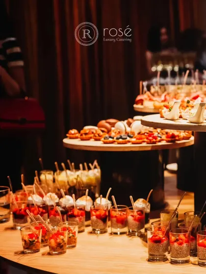 A vibrant spread of appetizers, including dessert cups and savory tarts. This display is perfect for a standing reception, offering guests a variety of sweet and savory options to enjoy while mingling.