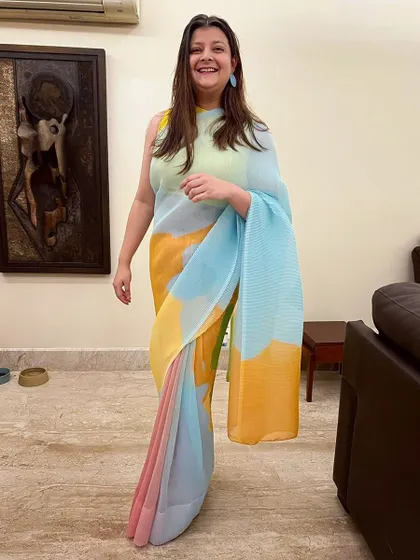 Dressed in all shades of happy. A client looking joyful and stylish in our multi-colored pleated saree, a light and fun option for a brunch or day event.