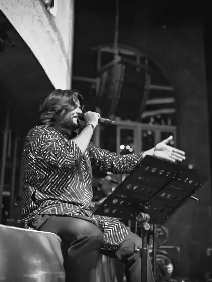 A black and white shot of me at the mic, capturing a moment of quiet intensity during a song.