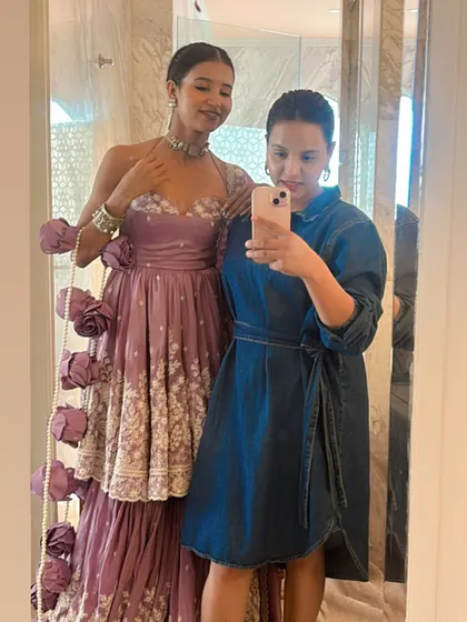 A mirror selfie with Nancy Tyagi, capturing her full look with the dramatic pearl-draped braid and her stunning lavender outfit.