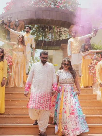A grand entry for the couple at their Haldi, with friends setting off colorful smoke bombs. This creates a dramatic and exciting start to the festivities.
