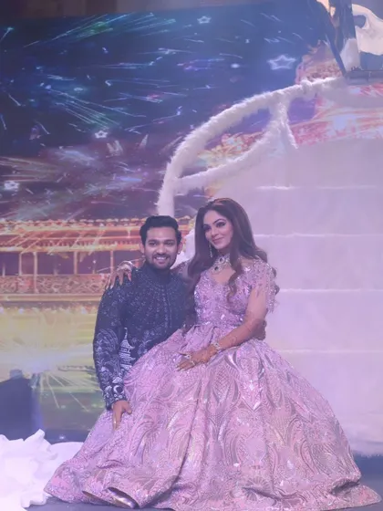 A classic portrait on their fairytale-themed reception stage. The couple looks happy and relaxed, ready to celebrate with their loved ones.